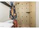 A tiled shower stall with a fun, modern shower curtain and adjustable shower head at 844 E Ruth Ave, Phoenix, AZ 85020