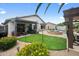 Backyard featuring a covered patio, pool, and well-maintained artificial grass, ideal for outdoor living at 8776 E Brilliant Sky Cir, Gold Canyon, AZ 85118