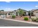Beautiful front yard, with desert landscaping, a two-car garage, and an inviting entrance at 8776 E Brilliant Sky Cir, Gold Canyon, AZ 85118