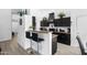 Stylish kitchen featuring black cabinets, granite countertops, breakfast bar, and stainless steel appliances at 8776 E Brilliant Sky Cir, Gold Canyon, AZ 85118