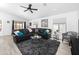 Open living room with a ceiling fan, and a modern black leather couch with a gray shag carpet at 8776 E Brilliant Sky Cir, Gold Canyon, AZ 85118
