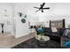 Spacious living room featuring sleek black leather seating and open view into the dining area at 8776 E Brilliant Sky Cir, Gold Canyon, AZ 85118