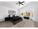 Sunlit bedroom with vaulted ceiling, large windows overlooking the pool, and stylish black accents at 8776 E Brilliant Sky Cir, Gold Canyon, AZ 85118