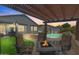 Cozy outdoor patio with a pergola, fire pit, and seating area near the pool, perfect for entertaining at 8776 E Brilliant Sky Cir, Gold Canyon, AZ 85118