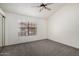 Bedroom featuring neutral carpet, vaulted ceilings, a window, and closet with mirrored doors at 921 W University Dr # 1232, Mesa, AZ 85201
