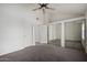 Large bedroom featuring neutral carpet, closet with mirrored doors, and a window at 921 W University Dr # 1232, Mesa, AZ 85201