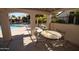 Under the cabana by the pool, a cozy table and chairs provide the perfect hangout spot at 921 W University Dr # 1232, Mesa, AZ 85201