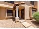 Charming townhome entrance with dual doors, desert landscaping, and pillar-supported entryway at 921 W University Dr # 1232, Mesa, AZ 85201