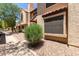 Attractive townhome with neat desert landscaping, complemented by mature trees and a clean sidewalk at 921 W University Dr # 1232, Mesa, AZ 85201