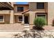 Charming townhome featuring a covered carport, desert landscaping, and inviting front entryway at 921 W University Dr # 1232, Mesa, AZ 85201