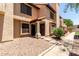 Inviting townhome showcasing desert landscaping and a cozy entryway with a wreath-adorned door at 921 W University Dr # 1232, Mesa, AZ 85201