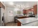 Well-lit kitchen boasts stainless appliances, wood cabinets, and a convenient door to the exterior at 921 W University Dr # 1232, Mesa, AZ 85201