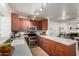 Charming kitchen features stainless appliances, and hardwood cabinets with ample counter space at 921 W University Dr # 1232, Mesa, AZ 85201
