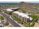 Aerial view showcasing the complex with desert landscaping, multiple units, and ample parking in a picturesque setting at 9820 N Central Ave # 212, Phoenix, AZ 85020