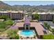 Aerial view of the community pool and amenity area with inviting pool, lounge chairs, and landscaped surroundings at 9820 N Central Ave # 212, Phoenix, AZ 85020