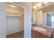 Bathroom vanity next to closet with a combination of shelving and rods at 9820 N Central Ave # 212, Phoenix, AZ 85020