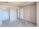 Bedroom featuring tan walls, carpeted floors, and closet with storage at 9820 N Central Ave # 212, Phoenix, AZ 85020