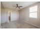 Bedroom with neutral carpet and walls, ceiling fan, and connected bathroom at 9820 N Central Ave # 212, Phoenix, AZ 85020