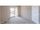 Bedroom with beige walls, carpet, balcony access and views at 9820 N Central Ave # 212, Phoenix, AZ 85020