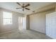 Bedroom with neutral carpet and walls, ceiling fan, and natural light at 9820 N Central Ave # 212, Phoenix, AZ 85020
