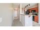 Hallway entrance to kitchen with views of the kitchen, backsplash, and lighting at 9820 N Central Ave # 212, Phoenix, AZ 85020