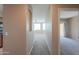 Hallway leading to living area with carpeted floors and neutral colored walls at 9820 N Central Ave # 212, Phoenix, AZ 85020