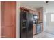Kitchen with stainless steel appliances, wood cabinets, and wine rack at 9820 N Central Ave # 212, Phoenix, AZ 85020