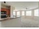 Kitchen overlooking the living room with lots of natural light and carpet flooring at 9820 N Central Ave # 212, Phoenix, AZ 85020