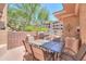 Inviting outdoor patio area with a built-in grill, table, chairs, and lush landscaping offers a relaxing outdoor experience at 9820 N Central Ave # 212, Phoenix, AZ 85020
