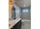 Bathroom featuring modern vanity with double sinks, attractive light fixture and patterned shower tiles at 1010 W 13Th St, Tempe, AZ 85281