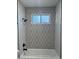 Modern bathroom features patterned tiles around a window in a tiled shower at 1010 W 13Th St, Tempe, AZ 85281