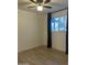 This bedroom features a ceiling fan, a window with black out curtains, and light wood flooring at 1010 W 13Th St, Tempe, AZ 85281