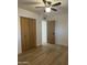 This bedroom features a ceiling fan, closets, and light wood flooring at 1010 W 13Th St, Tempe, AZ 85281