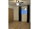 This bedroom features a ceiling fan, a window with black out curtains, and light wood flooring at 1010 W 13Th St, Tempe, AZ 85281