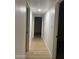 Hallway with white walls and wood-look flooring, creating a clean and modern aesthetic leading to rooms at 1010 W 13Th St, Tempe, AZ 85281