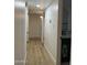 Bright hallway featuring wood-look floors and white walls, leading to the bathroom with a stylish gold-framed mirror at 1010 W 13Th St, Tempe, AZ 85281
