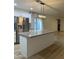 Kitchen featuring a large island, stainless steel refrigerator, and modern light fixture at 1010 W 13Th St, Tempe, AZ 85281