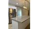 Spacious kitchen island complemented by stainless steel appliances, stylish curtains, and a modern light fixture at 1010 W 13Th St, Tempe, AZ 85281