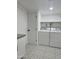 Practical laundry room with machines and storage shelves at 1010 W 13Th St, Tempe, AZ 85281