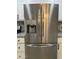 Stainless steel refrigerator complementing the white cabinets and patterned backsplash in a modern kitchen design at 1010 W 13Th St, Tempe, AZ 85281