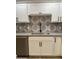 Modern kitchen sink with black faucet and white cabinets, complemented by a stylish patterned backsplash at 1010 W 13Th St, Tempe, AZ 85281