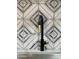 Close-up of a stylish black faucet and patterned tile backsplash, enhancing the sink area at 1010 W 13Th St, Tempe, AZ 85281