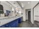 Modern bathroom with double sinks, marble countertop, and bright blue cabinets at 10638 E Honey Mesquite Dr, Scottsdale, AZ 85262