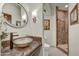Stylish bathroom featuring vessel sink, stone countertops, and luxurious tiled shower at 10638 E Honey Mesquite Dr, Scottsdale, AZ 85262