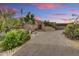 Stunning home exterior featuring desert landscaping and an inviting entryway at sunset at 10638 E Honey Mesquite Dr, Scottsdale, AZ 85262