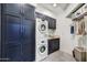 Convenient laundry room with washer, dryer, ample storage cabinets, and utility sink at 10638 E Honey Mesquite Dr, Scottsdale, AZ 85262