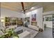 Bright living room featuring a fireplace, wood ceiling, and view to backyard at 10638 E Honey Mesquite Dr, Scottsdale, AZ 85262