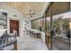Bright sunroom with wood ceiling, large windows, and cozy seating area overlooking the landscape at 10638 E Honey Mesquite Dr, Scottsdale, AZ 85262