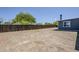 This spacious backyard features a privacy fence and mature trees at 11012 E Elton Ave, Mesa, AZ 85208