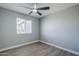This bedroom is freshly painted and features a ceiling fan and new flooring at 11012 E Elton Ave, Mesa, AZ 85208